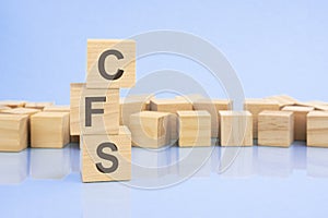 on a bright blue background, light wooden blocks and cubes with the text CFS