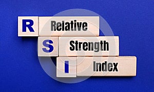 On a bright blue background, light wooden blocks and cubes with the text RSI Relative Strength Index