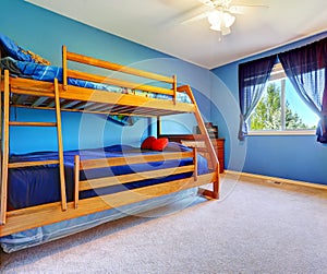 Bright blue bedroom with bulk bed