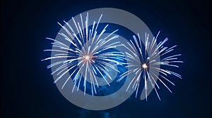 Bright blue fireworks explode against a dark night sky