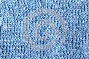 Bright blue knitted fabric texture. Rough sweater background