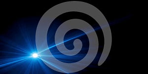 A bright blue light source emitting rays against a dark background creating a dramatic effect
