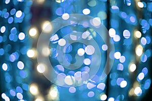 Bright blue lights bokeh effect from festive garland light unfocused blurred abstract