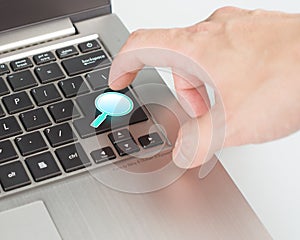Bright blue magnifier draw search button on the keyboard
