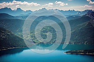 Bright blue mountain lake surrounded on all sides by impregnable rocks