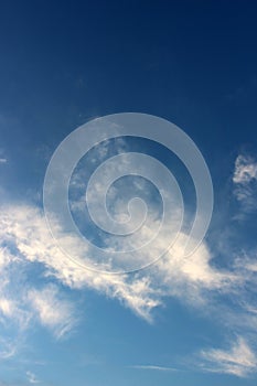 Bright blue skies with puffy cloud cover and bright sunlight