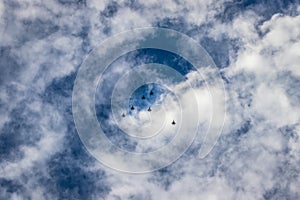 Bright blue sky with jet fighter formation flying