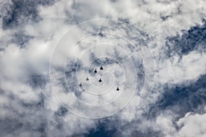 Bright blue sky with jet fighter formation flying