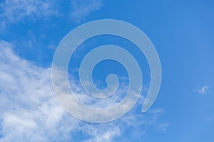 Bright blue sky with whispy white cloud - copy space