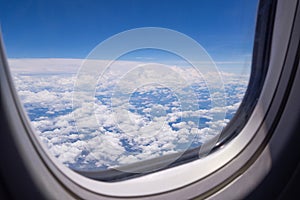 Bright blue sky and white clouds. Beautiful above sky panoramic view from the window of an airplane flying in the clouds. Feeling