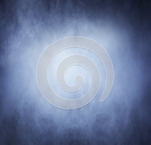 Bright blue smoke over black background