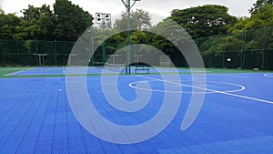 The bright blue tennis and futsal courts