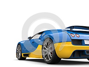 Bright blue and yellow modern super sports car - tail view cut shot