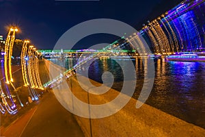 Bright blurred colorful background of night city with bridge. Neon bright reflections, light trails, multicolored bokeh, modern