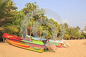 Bright boats on the tropical beach of Bentota, Sri Lanka on a sunny day