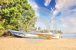 Bright boats on the tropical beach of Bentota, Sri Lanka on a sunny day