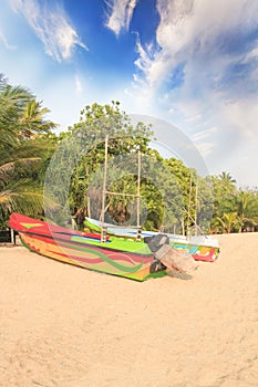 Bright boats on the tropical beach of Bentota, Sri Lanka on a sunny day