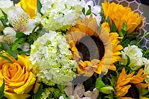 Bright bouquet with yellow sunflowers and rose, pink eustoma and green viburnum floral background
