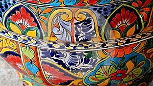 A bright and busy painted talavera plant pot.