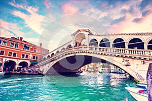 Bright charming landscape with Rialto Bridge at sunset in Venice, Italy. Amazing places. Popular tourist atraction photo