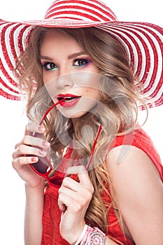 Bright cheerful girl in summer hat, colorful make-up, curls and pink manicure. Beauty face.