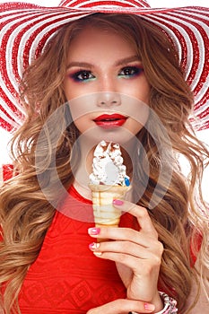 Bright cheerful girl in summer hat, colorful make-up, curls, pink manicure and ice cream in the hands. Beauty face.