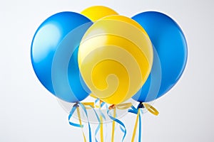 Bright and cheerful yellow and blue balloon floating gracefully on a clean white background