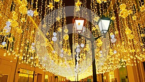 Bright Christmas Street Illumination. The City is Decorated for the Christmastide Holiday. New Year Lights Decorating