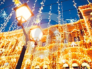 Bright Christmas Street Illumination on the facade of the buildings. The City is Decorated for the Christmastide Holiday. New Year