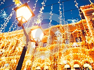 Bright Christmas Street Illumination on the facade of the buildings. The City is Decorated for the Christmastide Holiday. New Year photo