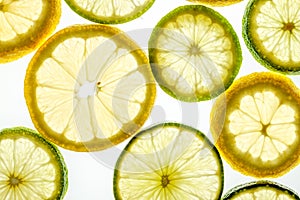 Bright citrus lime and lemon slices on white