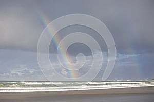 A bright and clear rainbow in a cloudy sky