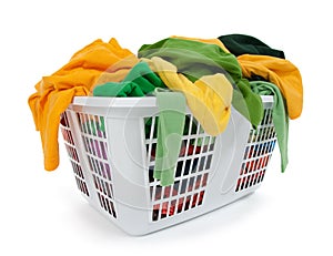 Bright clothes in laundry basket. Green, yellow.