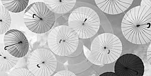 Bright color umbrellas hanging on blue sky background bottom-up