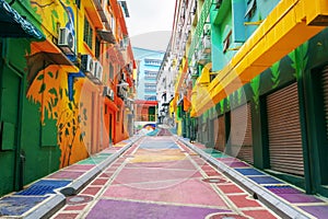 Bright colored backstreet with walls painted in graffiti style. Modern urban environment