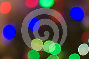 Bright colored circles on a dark background for Christmas holiday greetings.