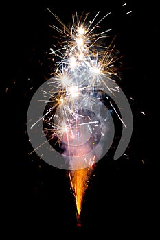 Bright colored fireworks stand out against a black background. Bright festive fireworks and sparkler on a black
