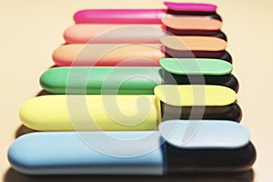 Bright colored markers for highlighting text on beige background, colored felt-tip pens for drawing