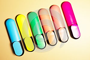 Bright colored markers for highlighting text on beige background, colored felt-tip pens for drawing