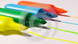 Bright colored markers for highlighting text on white background, colored felt-tip pens for drawing