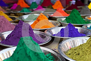Bright colored paints in India.  Organic Gulal colours in bowl for Holi festival, Hindu tradition festive. Bright vibrant pigment