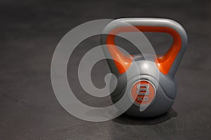 Bright colored plastic kettlebell weight weighing eight kilograms