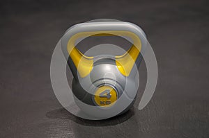 Bright colored plastic kettlebell weight weighing four kilograms