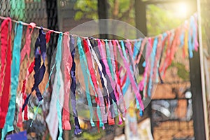 Bright colored ribbons hang and flutter in the wind. Fair holiday festival decoration. India, Goa, Arambol