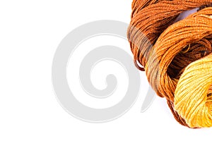 Bright colored skeins of floss threads on a white background