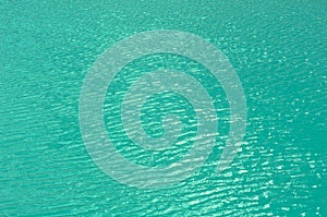 Bright, colorful background close up, turquoise green water surface lake, outdoors.
