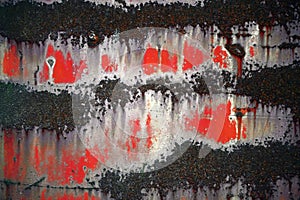 Bright colorful background from rusty metal with black, white and red shabby cracked paint