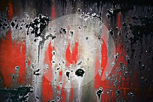 Bright colorful background from rusty metal with black, white and red shabby cracked paint
