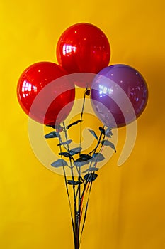 Bright and Colorful Balloon Bouquet Against a Yellow Background Party Decor Celebrations, Festive Vibrant Colors, Red and Purple