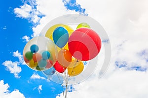 Bright colorful balloons over blue sky background